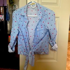 Striped blue and white blouse with tie at the bottom. Lashes and lip details.